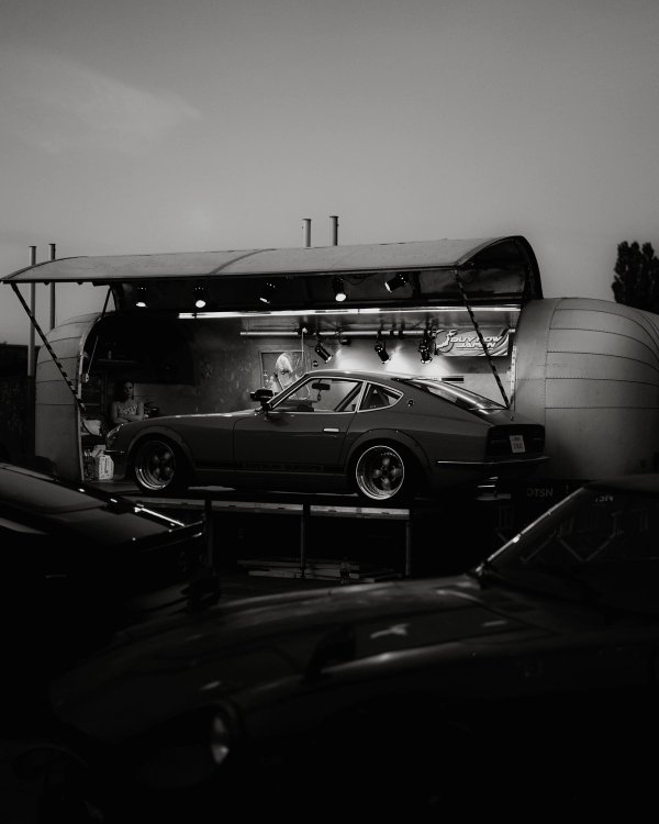 Silver Datsun 240Z displayed inside a modified aluminum trailer for Datsun Europe