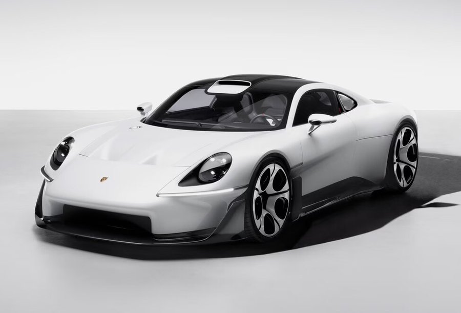 A white Porsche Mission S from the front three-quarter on a pale studio floor, with round headlights and a Porsche crest on the bonnet