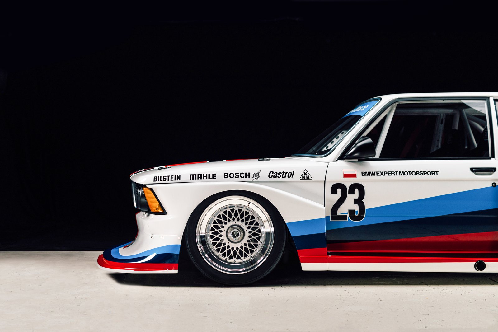 White BMW Motorsport E21 Group 5 side profile with number 23 and BMW Expert Motorsport livery