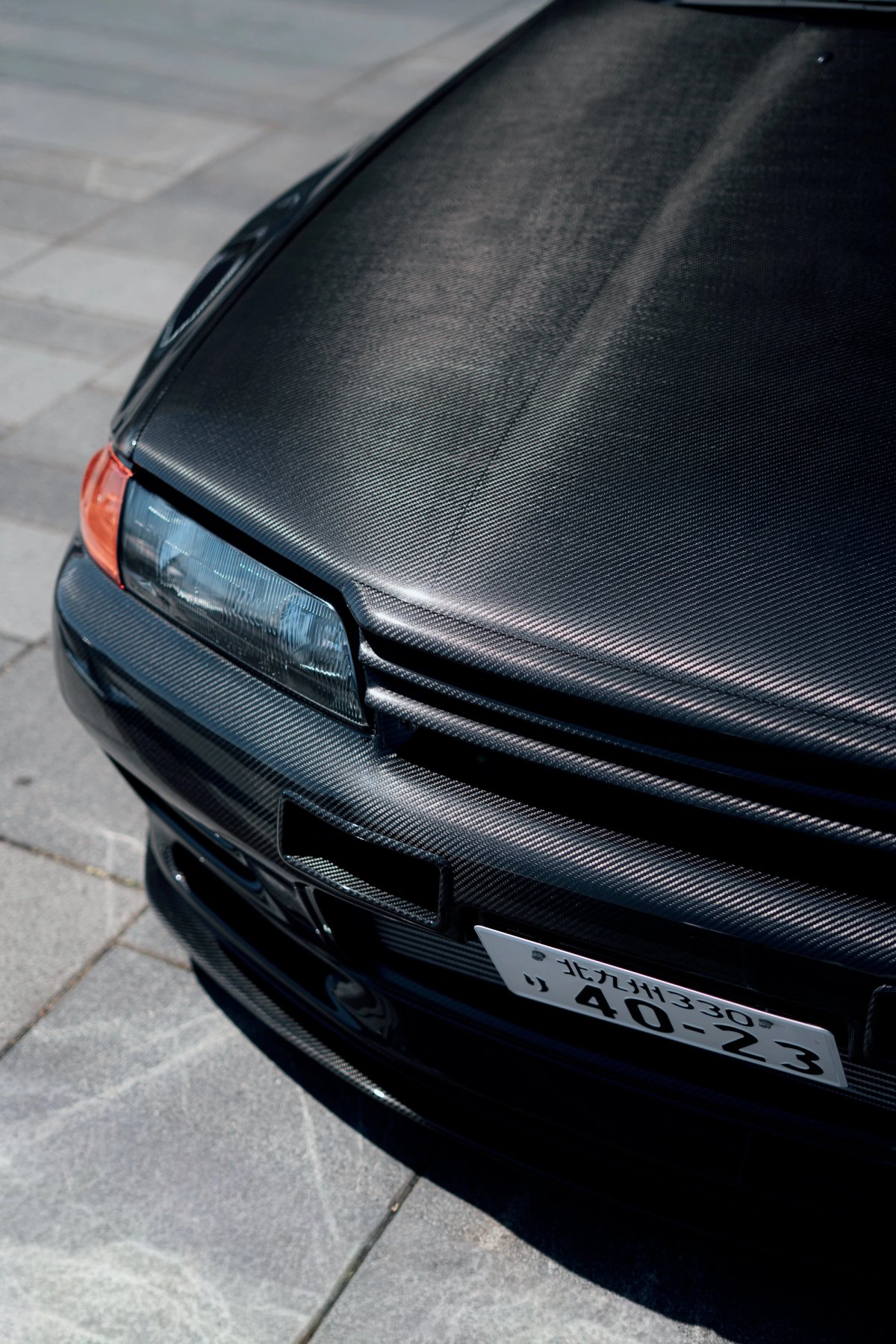 Full carbon-fiber front of Kazushige Sakamoto's Garage Active Nissan Skyline R32 GT-R with Japanese plates