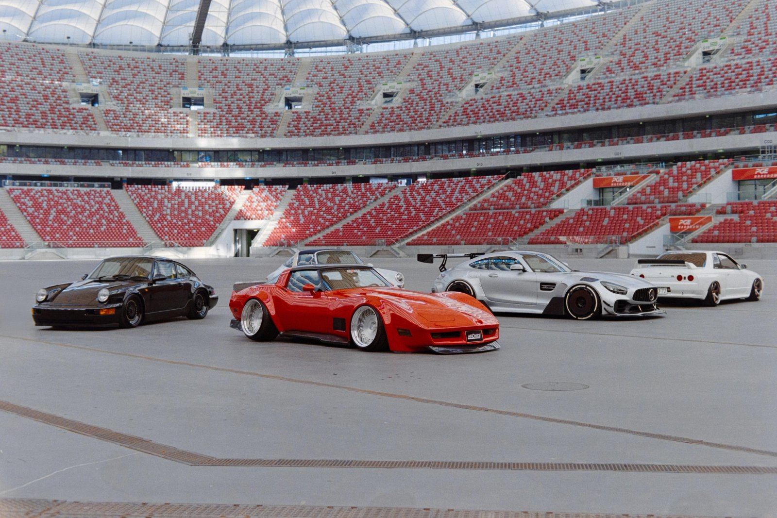 Five modified cars lined up on the field of PGE Narodowy stadium in Warsaw