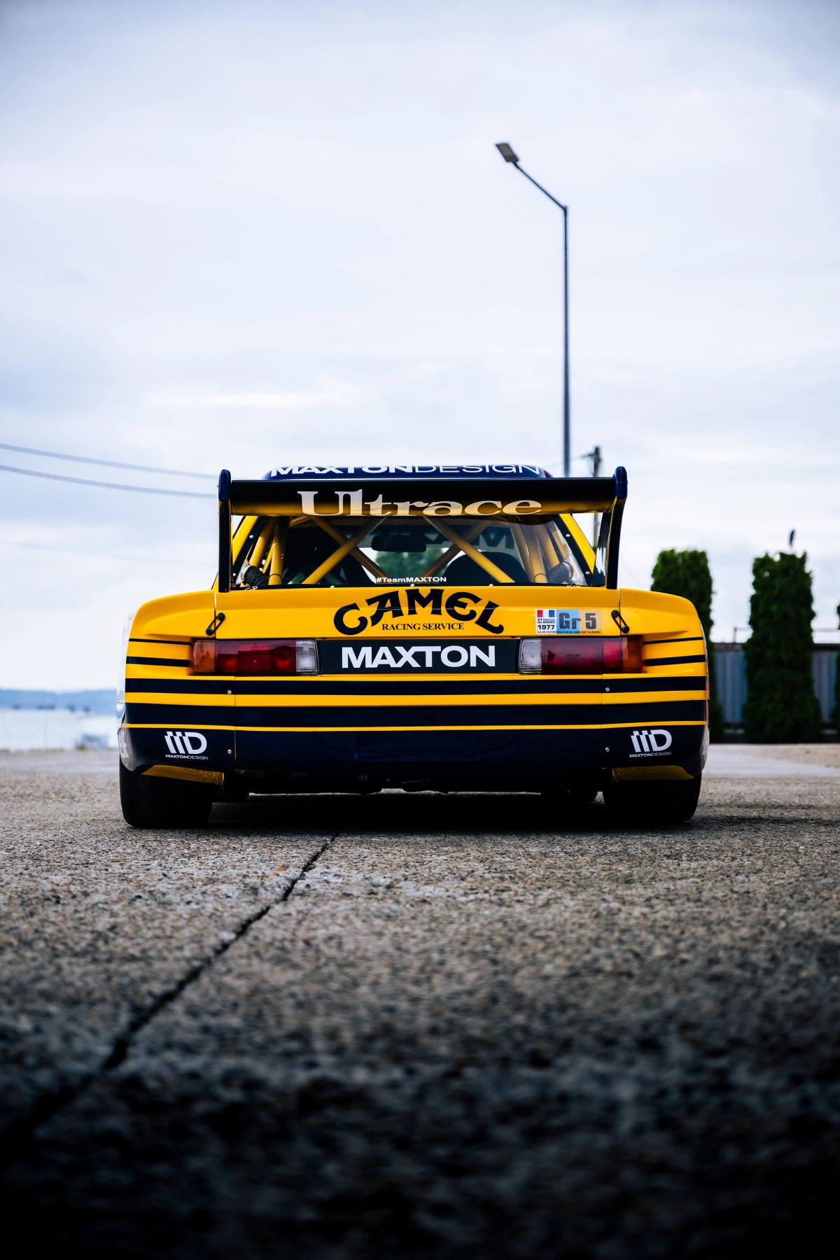 Yellow Camel BMW E21 Group 5 Maxton rear view with roll cage visible and massive rear wing