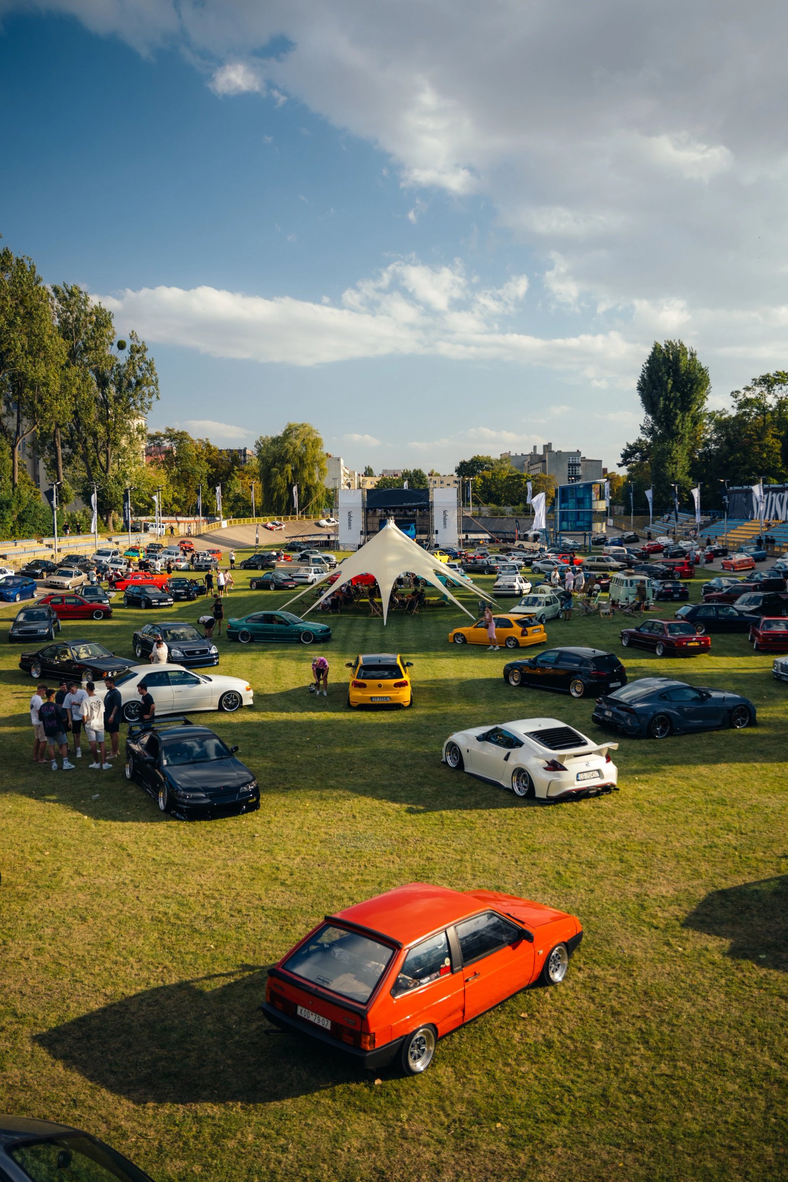Wide overview of the Substance event at the K.S. Społem velodrome with cars on infield and banking