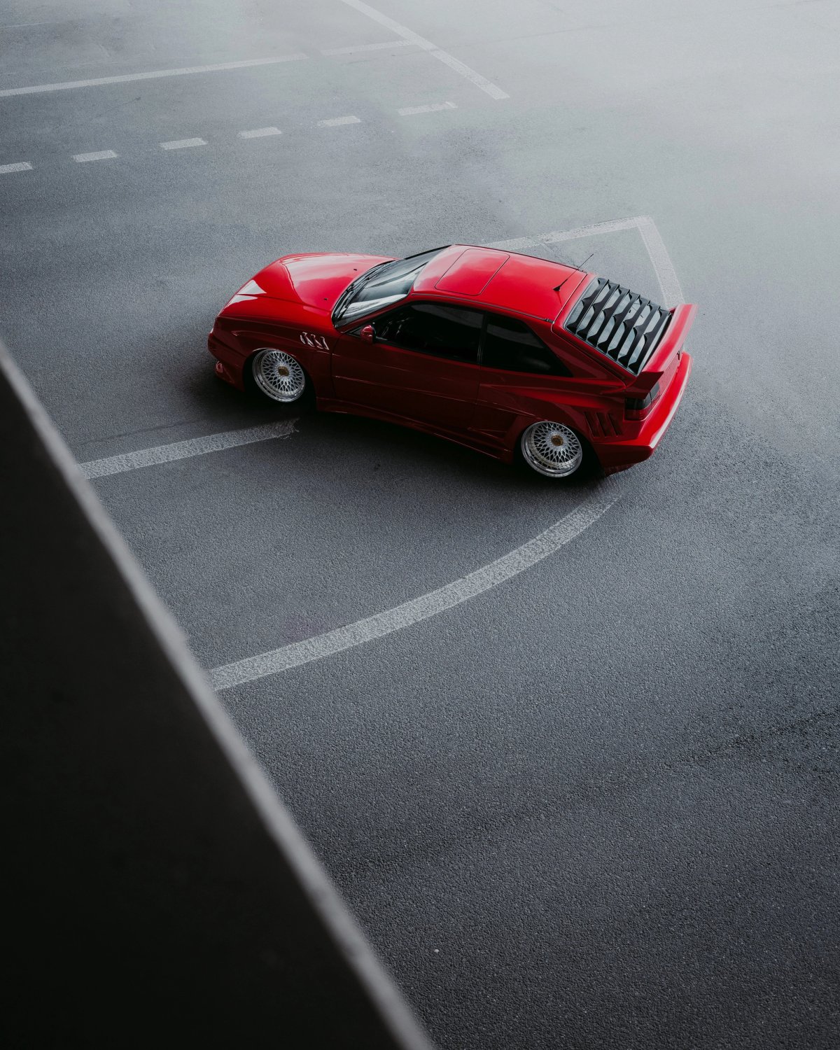 Red VW Corrado from above on misty parking lot with BBS wheels