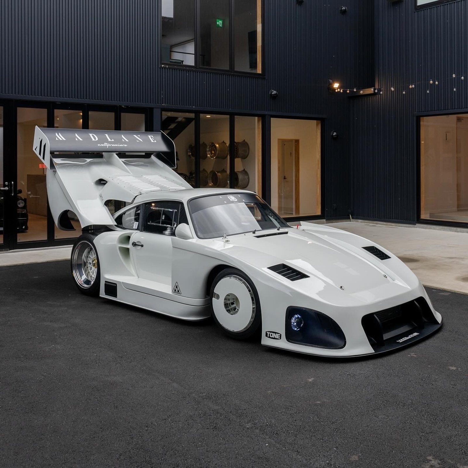 White Porsche 935ML front three-quarter view at Madlane headquarters