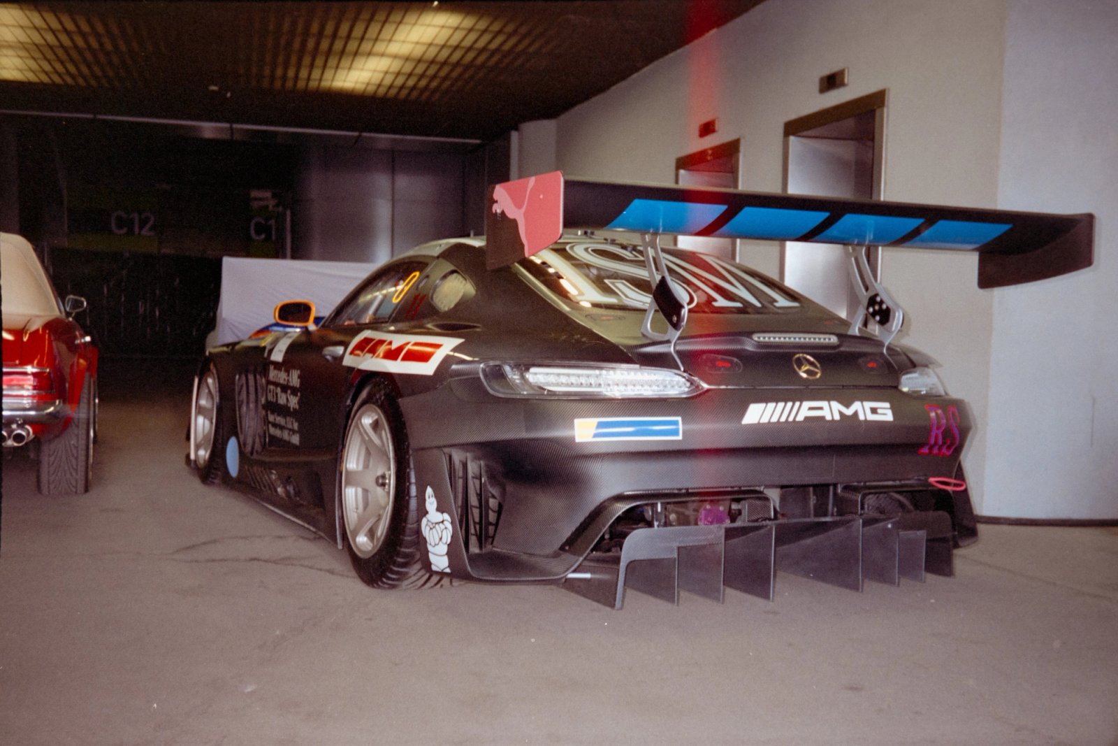 Race Service Mercedes AMG GT3 Raw Spec rear view in the paddock at night
