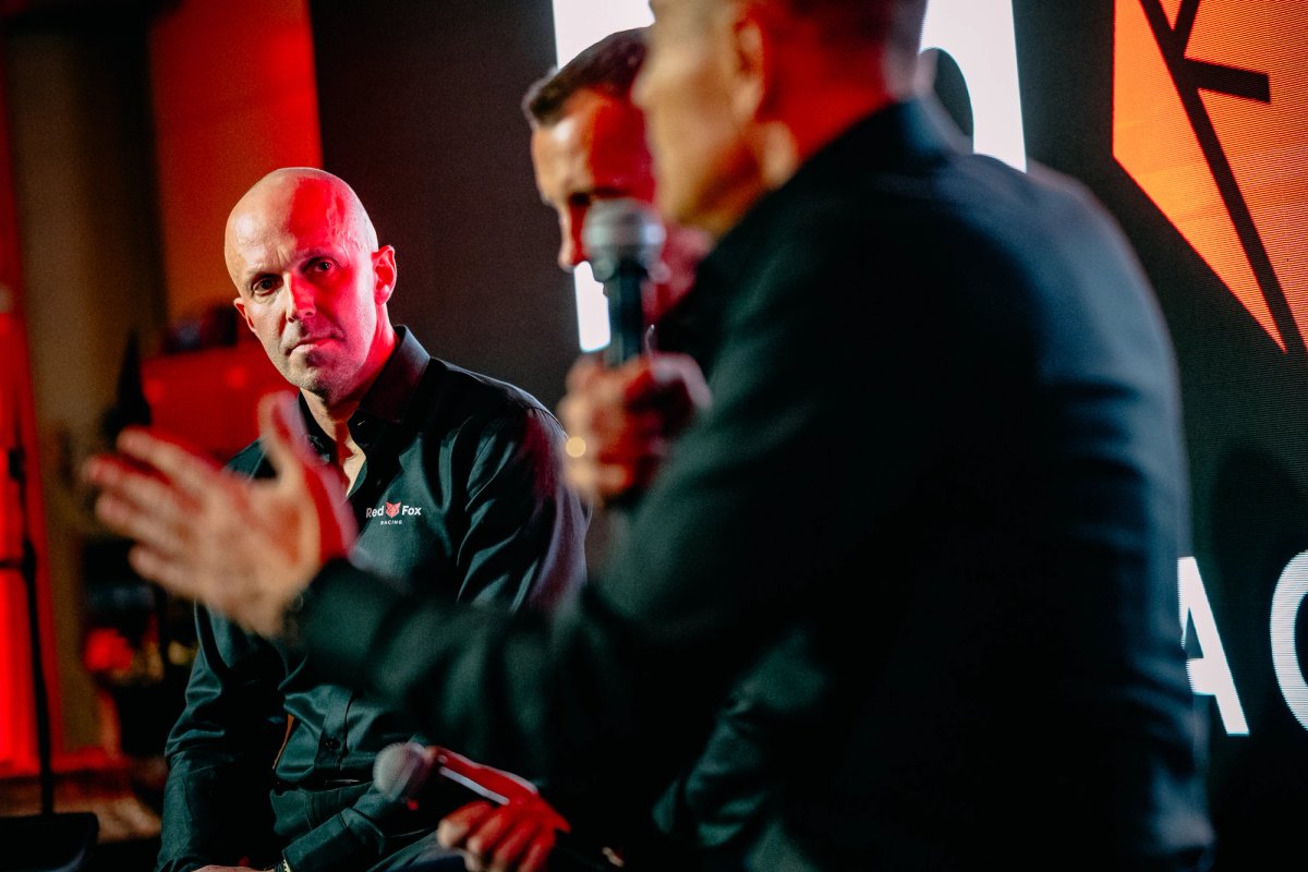 Edward Ruszczyc at the Red Fox Racing launch event under red ambient lighting