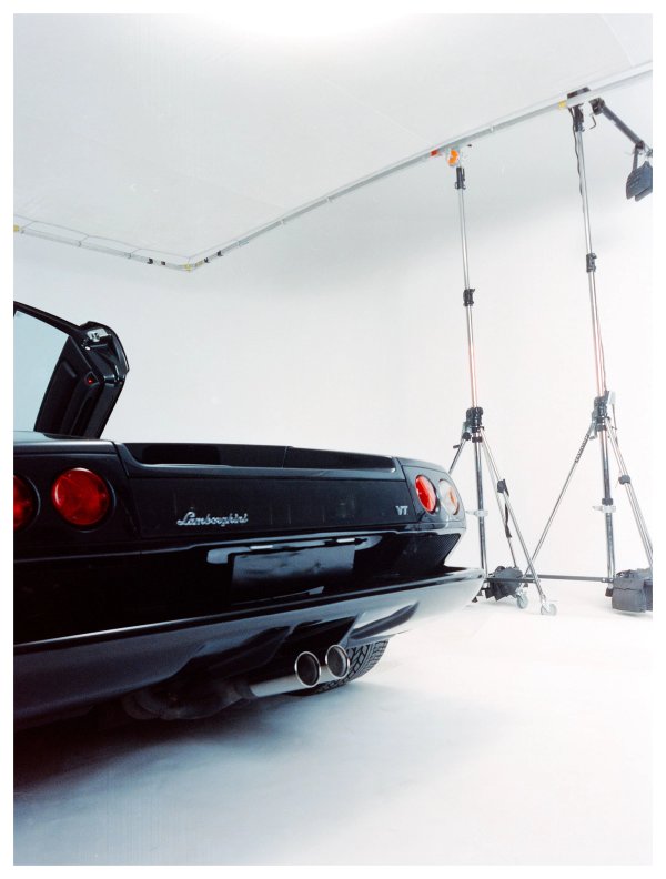 Black Lamborghini Diablo VT rear view in a white studio with tripods