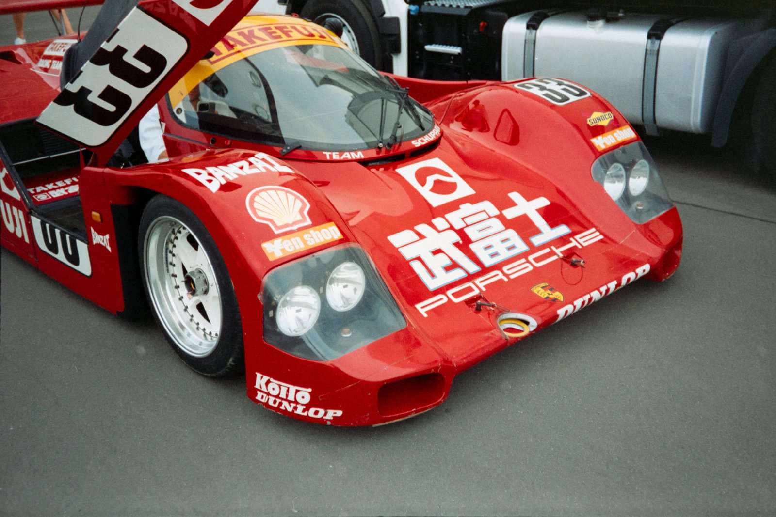 Porsche 962C Team Schuppan close-up front quarter with Takefuji livery and Dunlop stickers