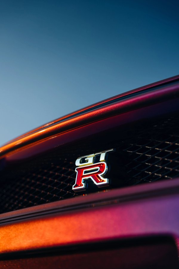 GT-R badge on purple Skyline rear grille with sunset light