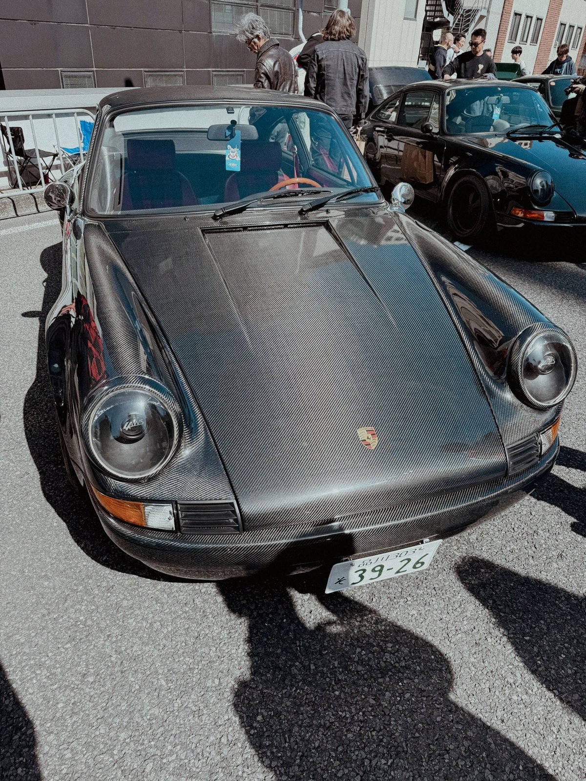 Early Porsche 911 with full carbon fibre bonnet from above showing frog-eye headlights