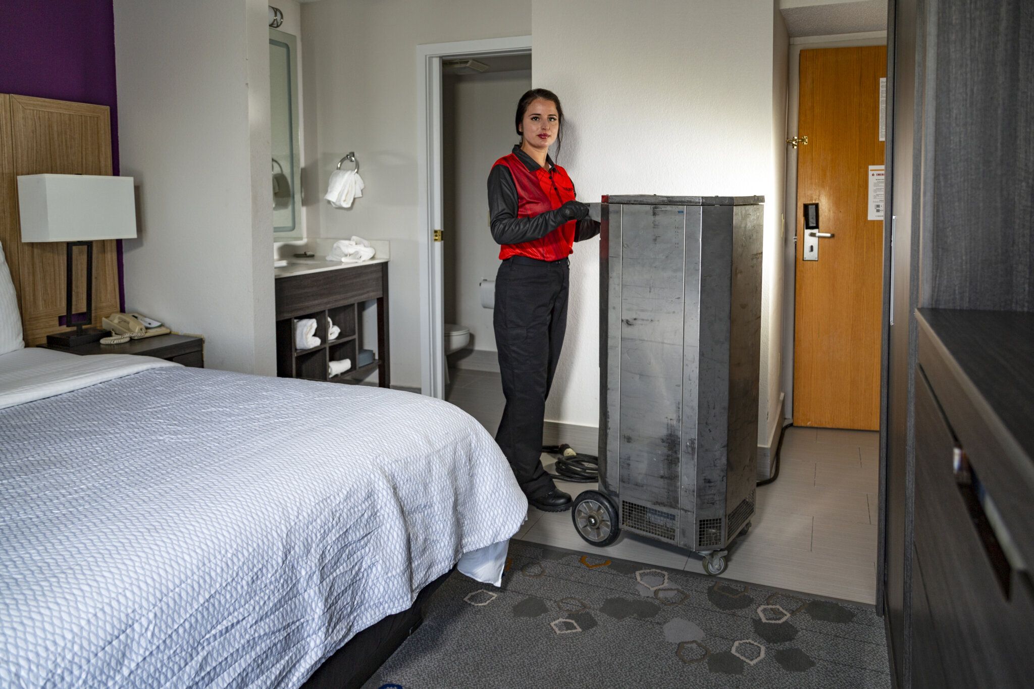 Image of Adam's Pest Technician carrying heat treatment equipment for Bed Bugs