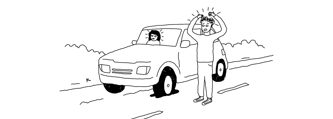 A car broken down with a flat tyre