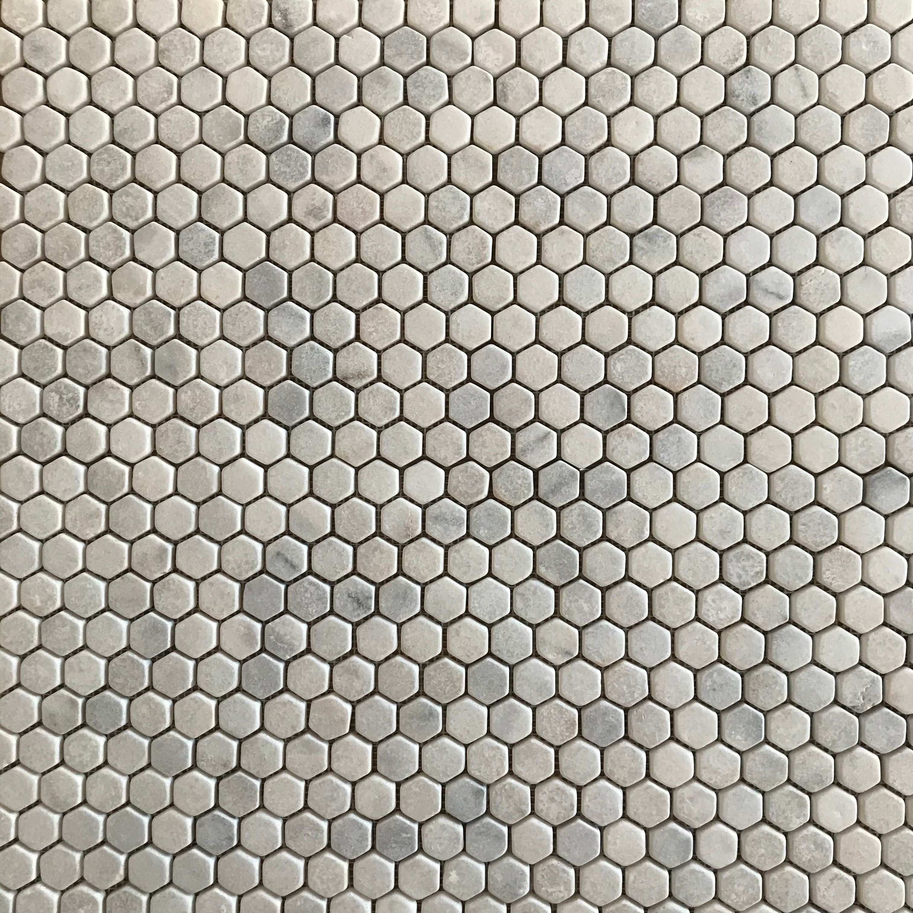 Tumbled Carrara White marble one-inch hexagon mosaic tile with cloudy grey veining thumbnail 2