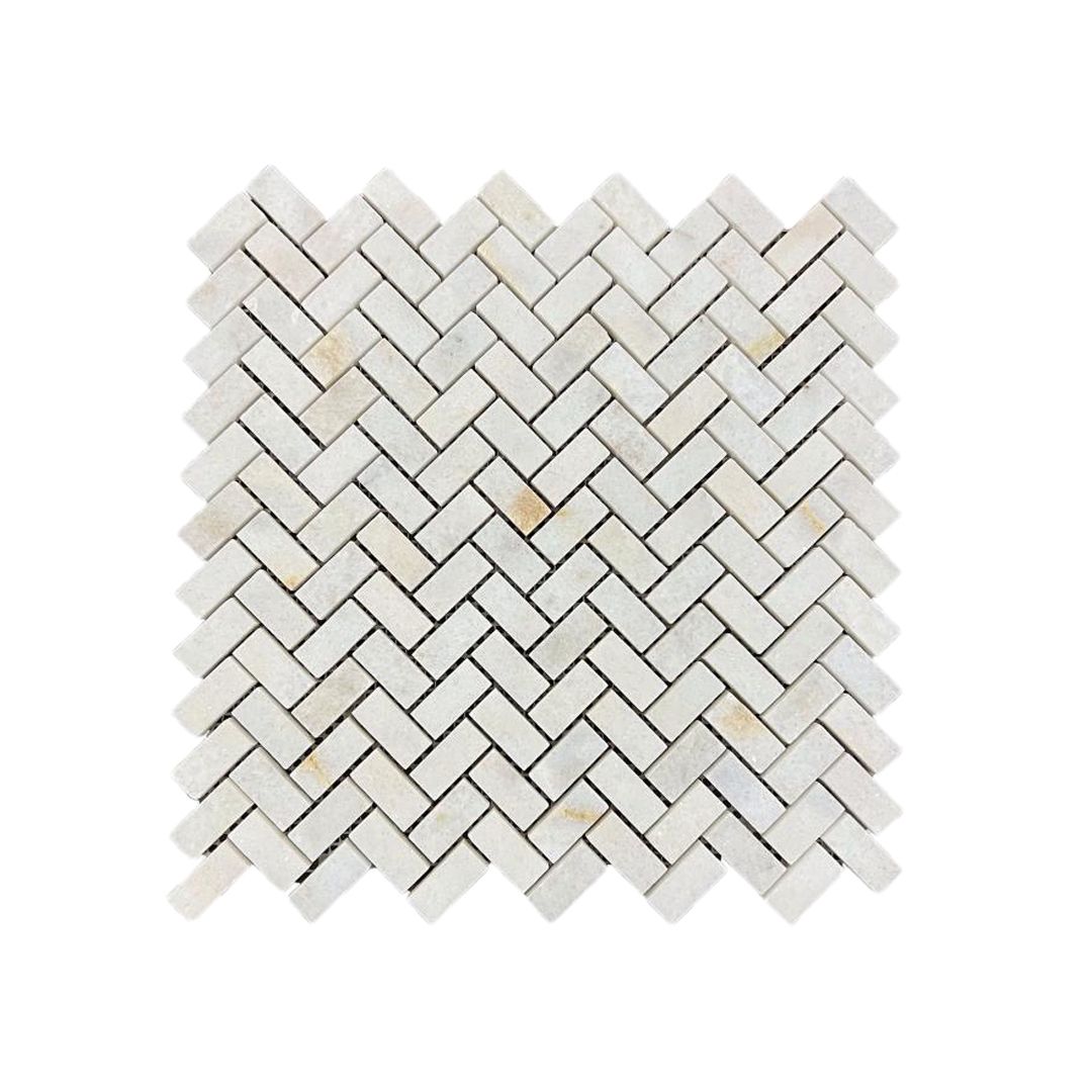 Honed Calacatta Sugar marble herringbone mosaic tile in warm white, cream and gold