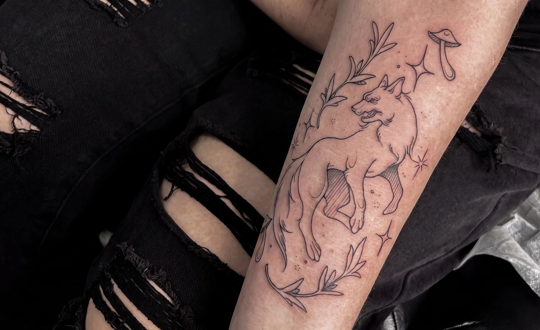 Fineline-Wolf mit Pilz und Zweigen am Bein — Tattoo von Melinda Dür aus Vorarlberg