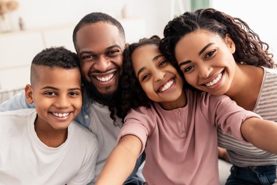 Good-looking African American family at home smiling family picture
