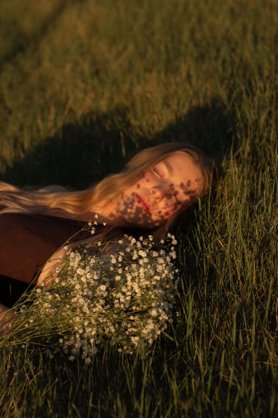 Lying in the grass, dappled light