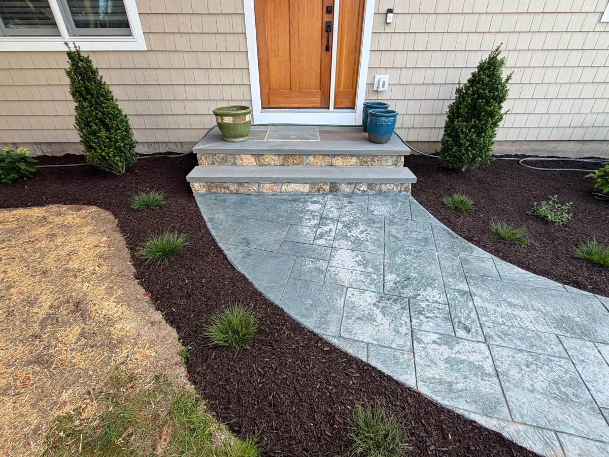 Stamped Concrete Steps with Stone Veneer Landing