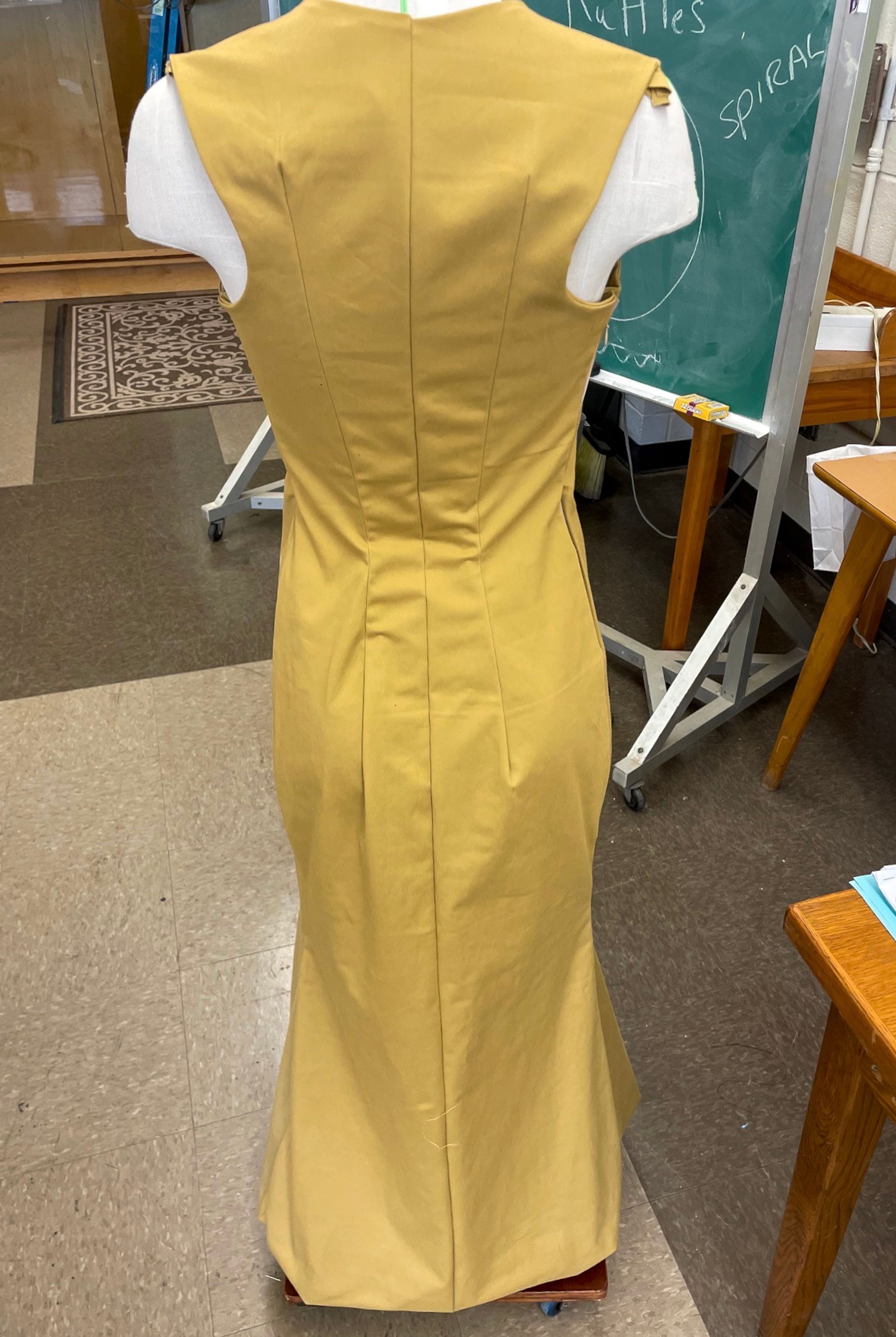 Yellow Satin Dress: The same dress from the back, seams shaped through the waist