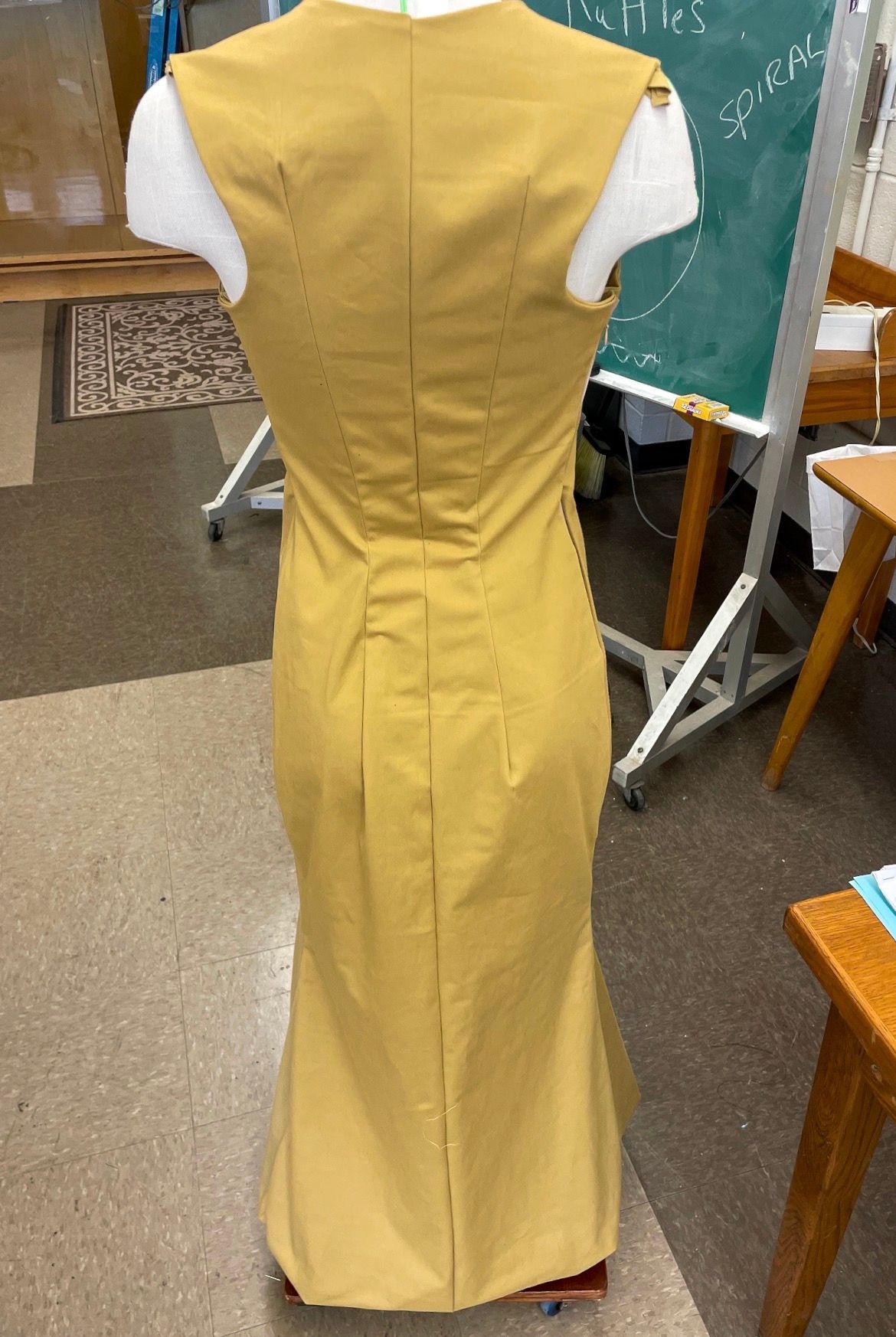 Yellow Satin Dress: The same dress from the back, seams shaped through the waist