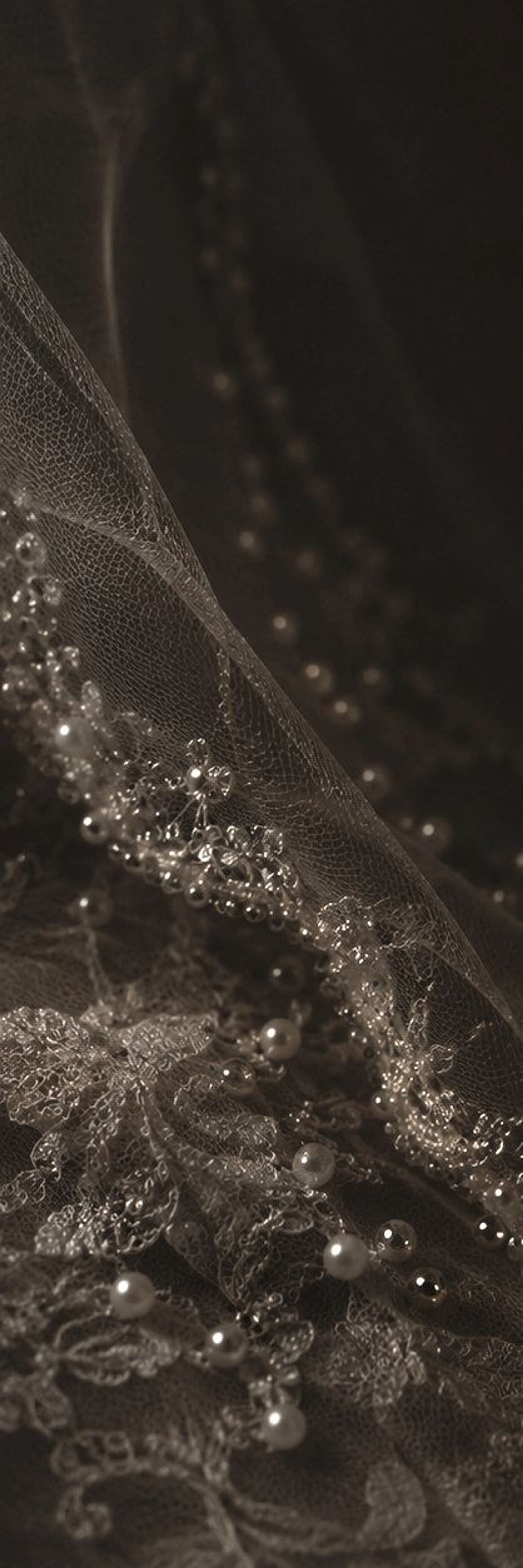 Beaded lace and pearls in low light
