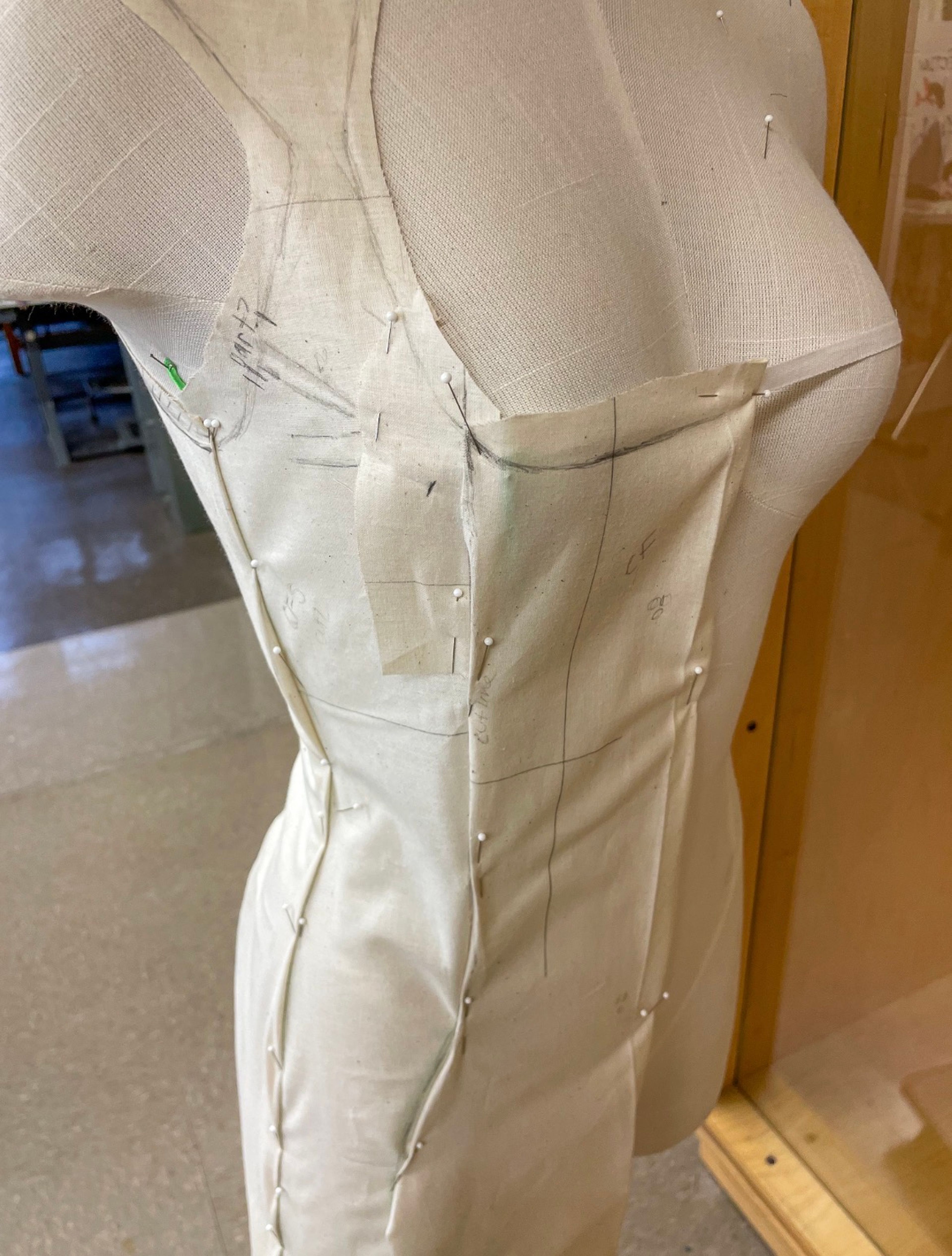 Bodice in Progress: Muslin bodice pinned and marked on the form