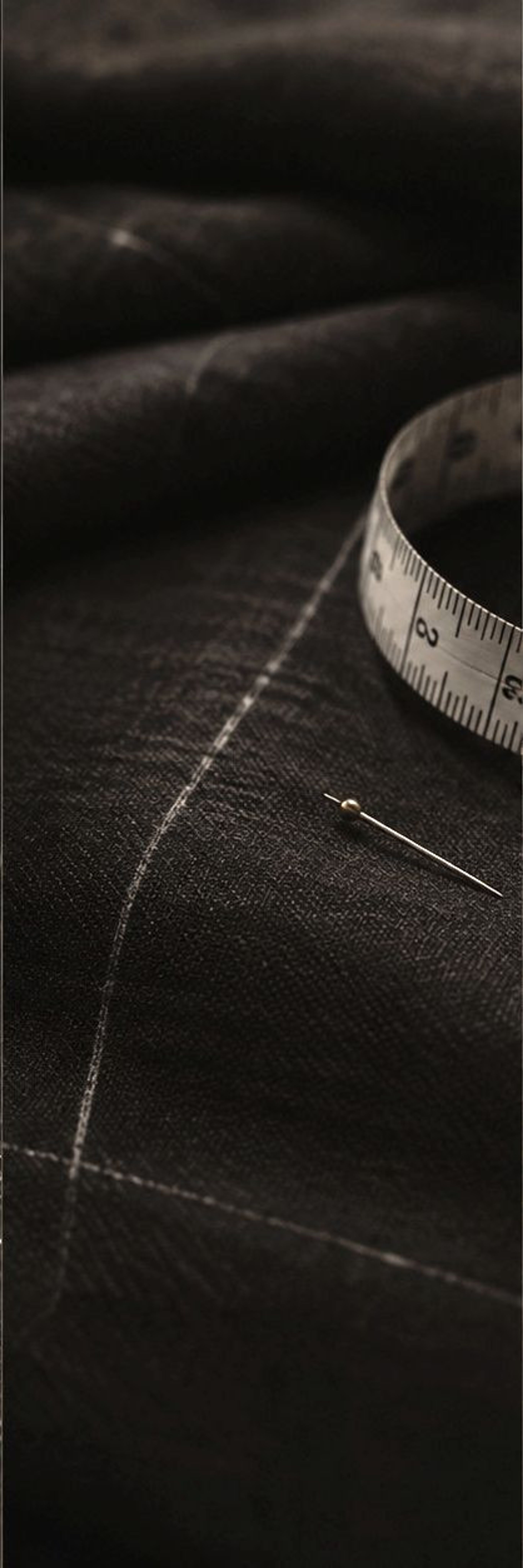 Charcoal wool with tape measure and pin
