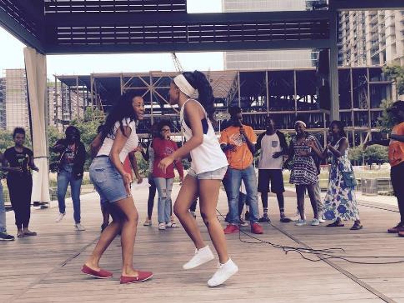 A young person performing spoken word on stage at Discovery Green