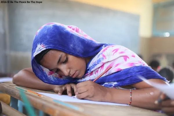 Children drawing images of happiness and hope