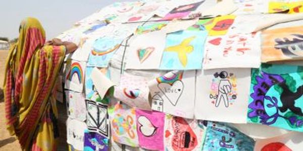Camp youth sewing their art together with artwork from Houston