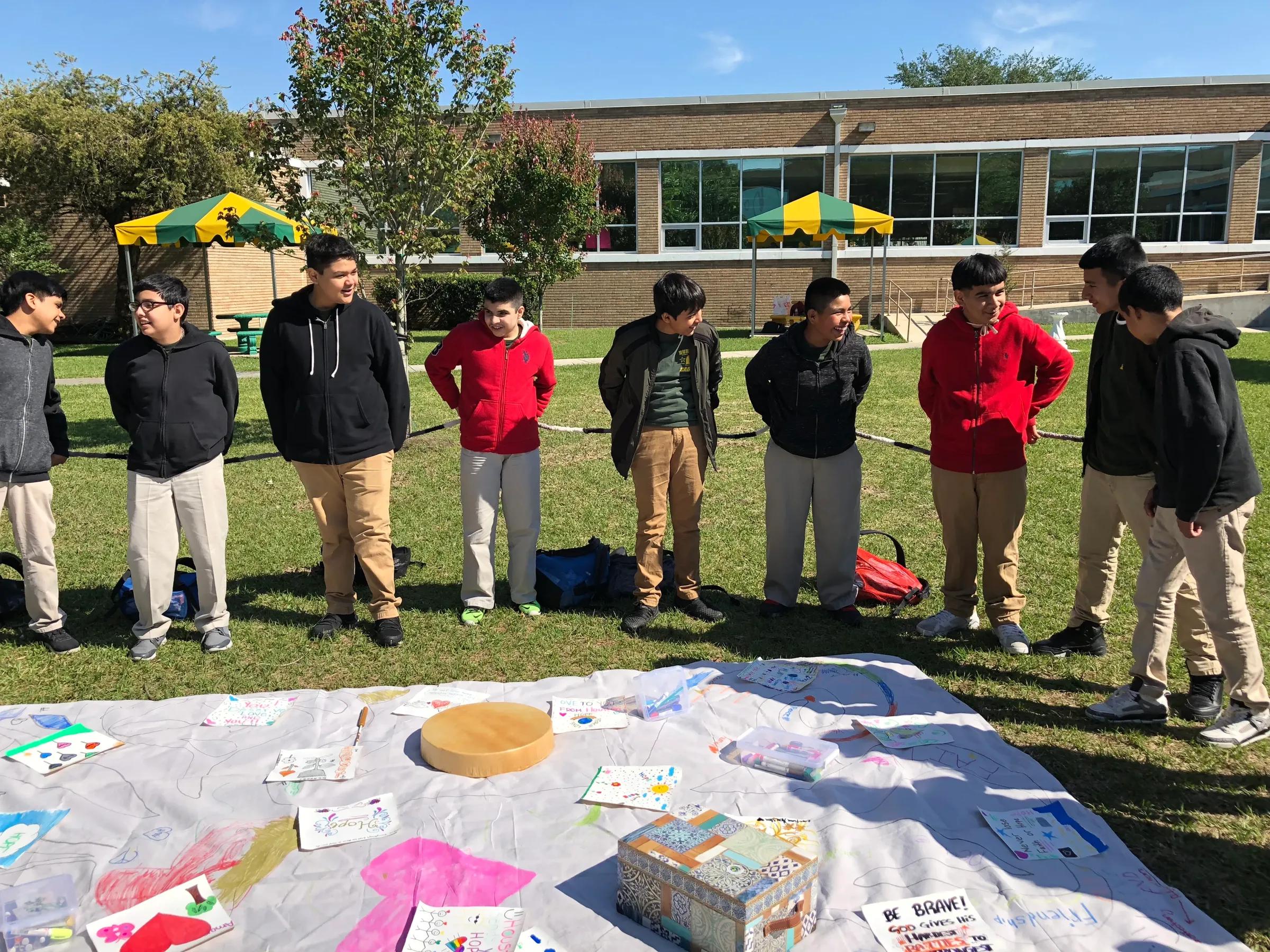 Students gathered in a circle on the school lawn