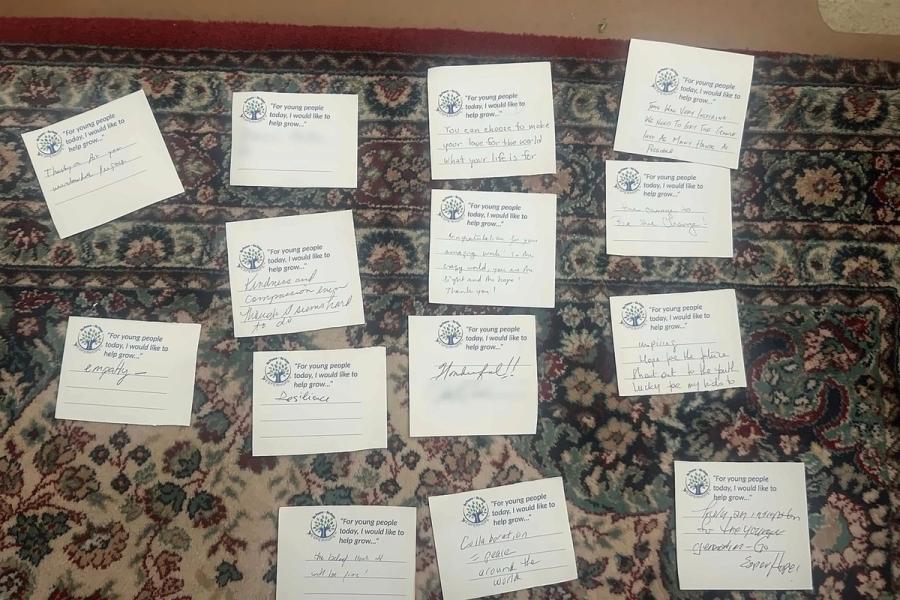 Guests’ handwritten cards finishing the line “For young people today, I would like to help grow…”