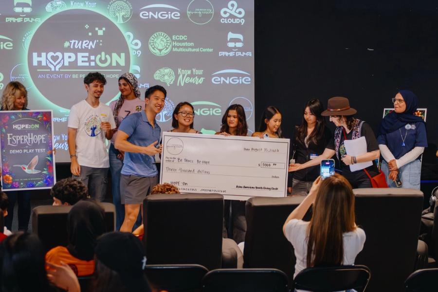 The Asian American Youth Giving Circle presents its check to Be Peace – Be Hope on stage at HOPE:ON