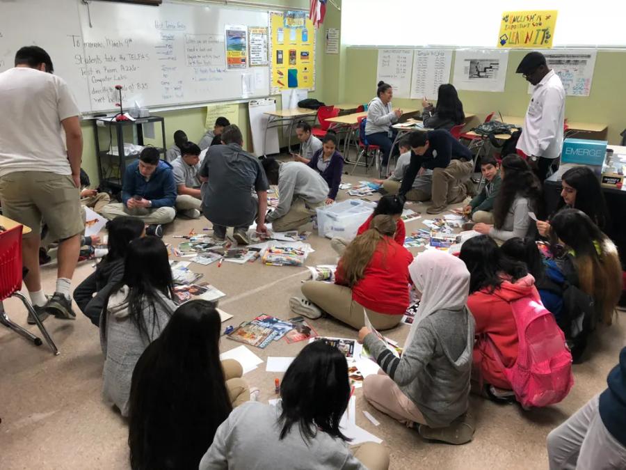 A large group of students gathered on the floor