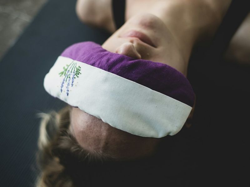 An eye pillow resting over closed eyes