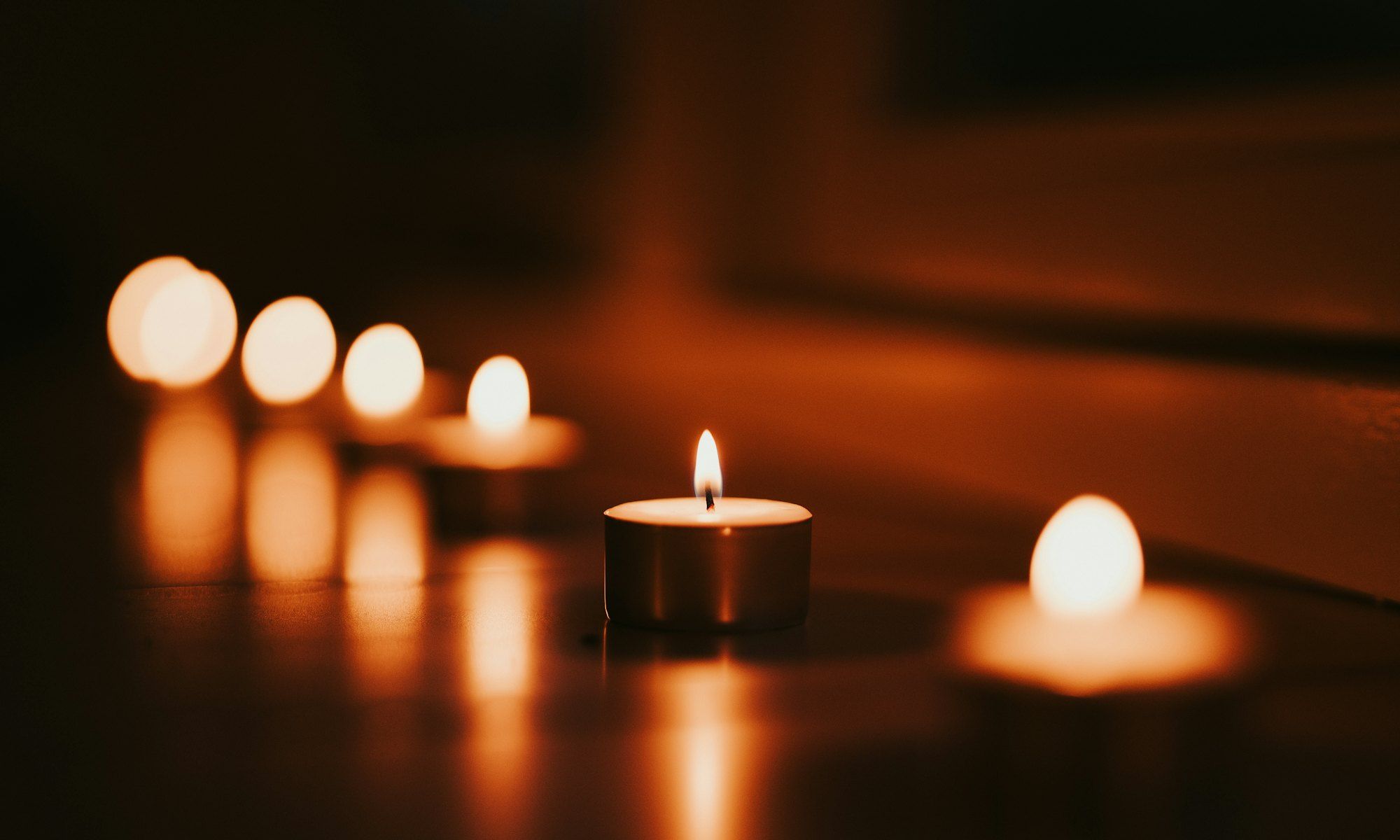Candles burning low in a dim room