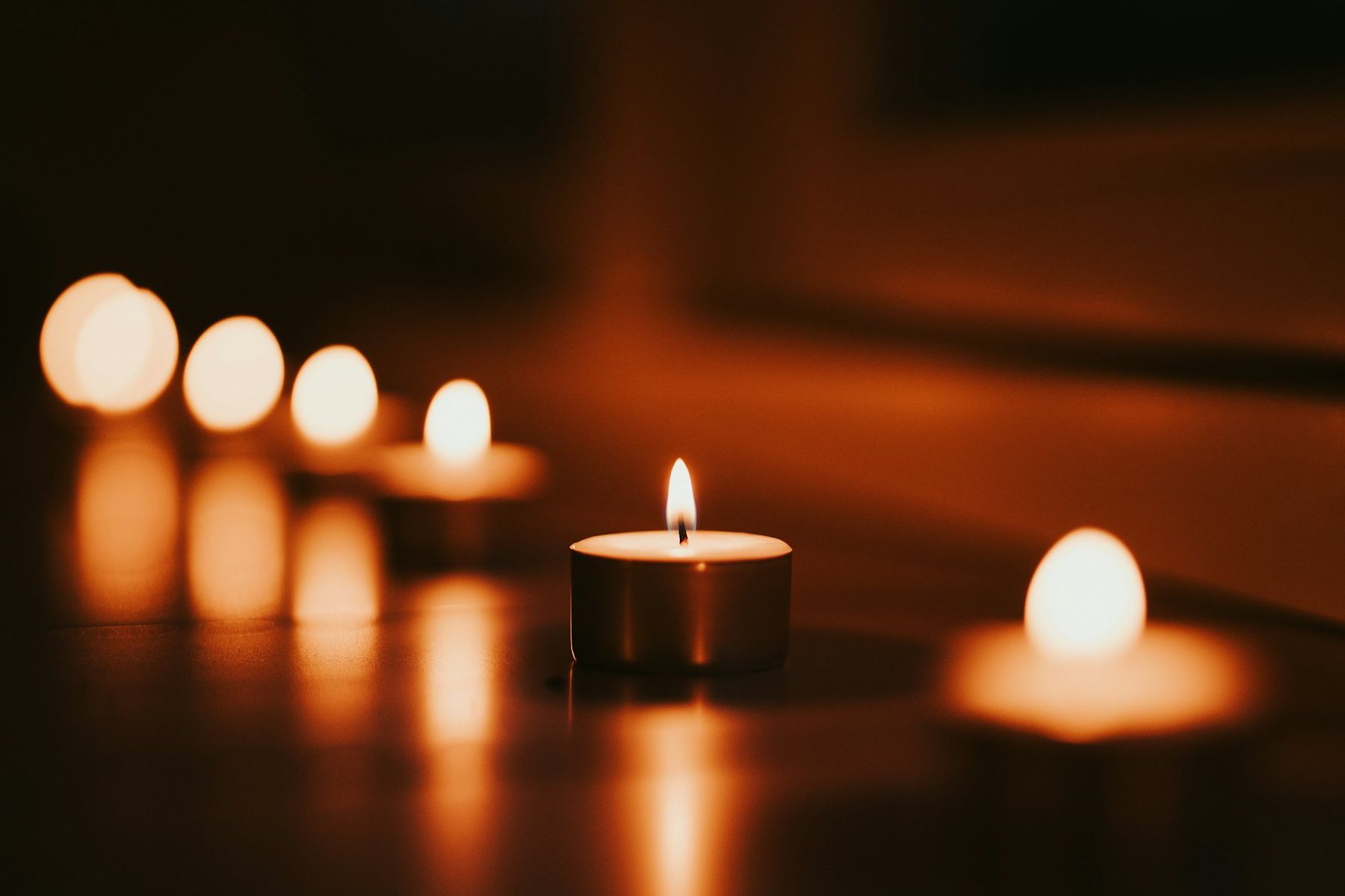 Candles burning low in a dim room