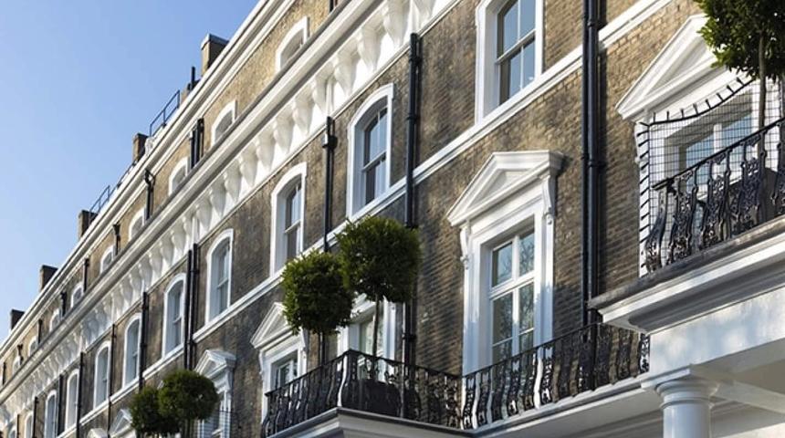 White sash windows with curved heads on a brick terrace