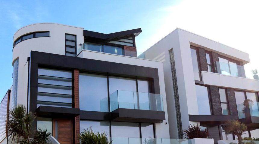 Modern white house with floor-to-ceiling glass and a glass balcony