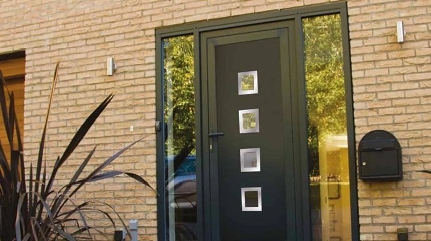 Dark front door with four square glass panels, set in brick with glazed side lights