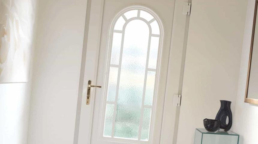 White front door with a tall arched glazed panel
