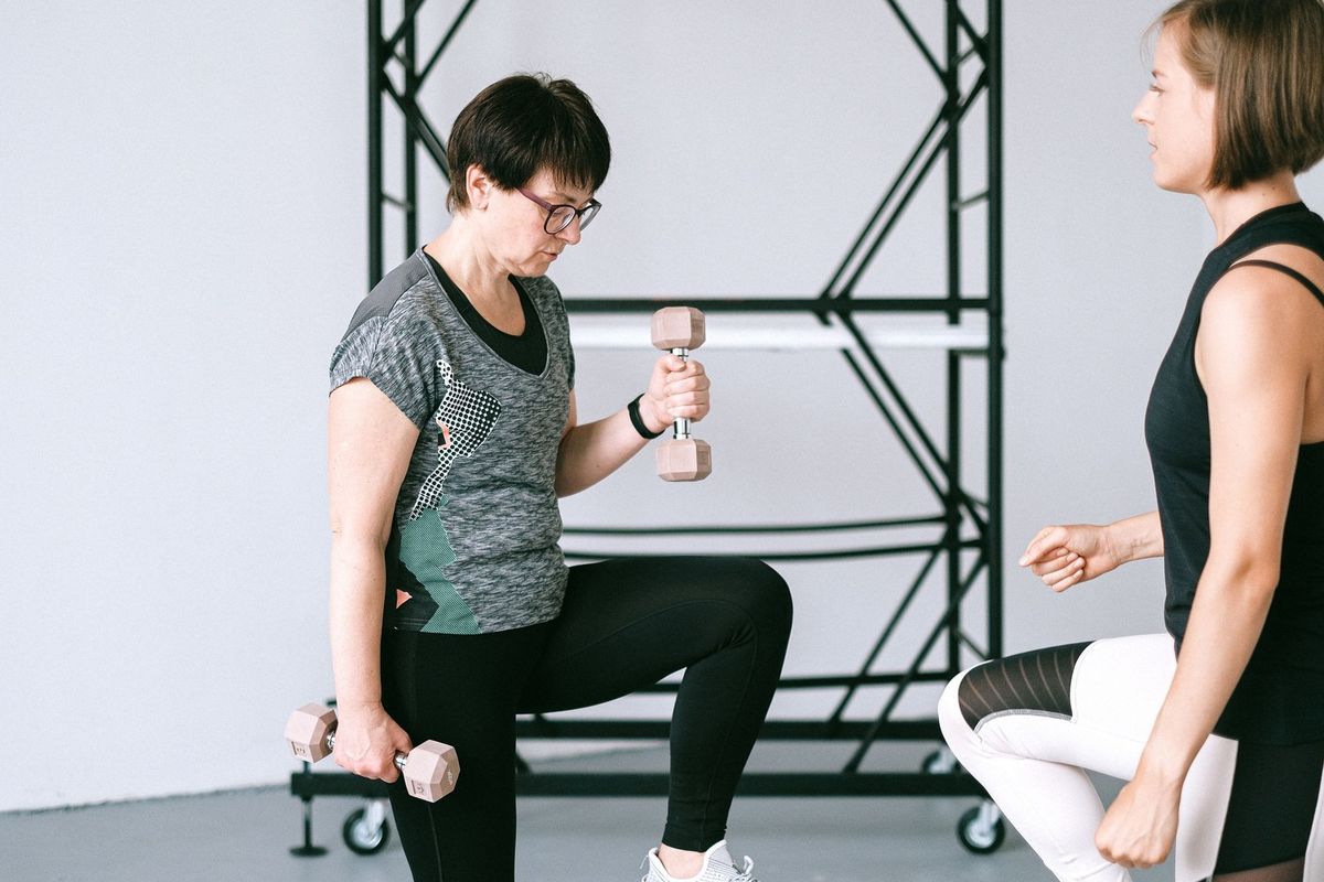 Adults performing controlled strength exercises with coaching in Chicago