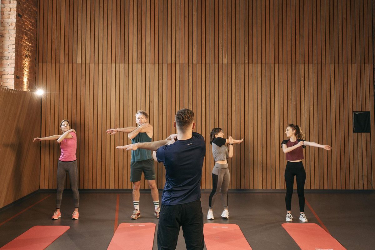 Adults training together in a small coached fitness group