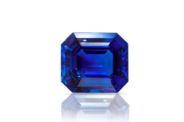 A deep, saturated royal-blue Burmese sapphire, photographed loose against a neutral background.