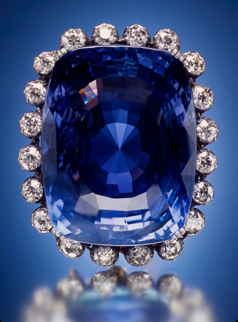 The Logan Sapphire, a large cushion-cut blue sapphire set in a diamond halo brooch.