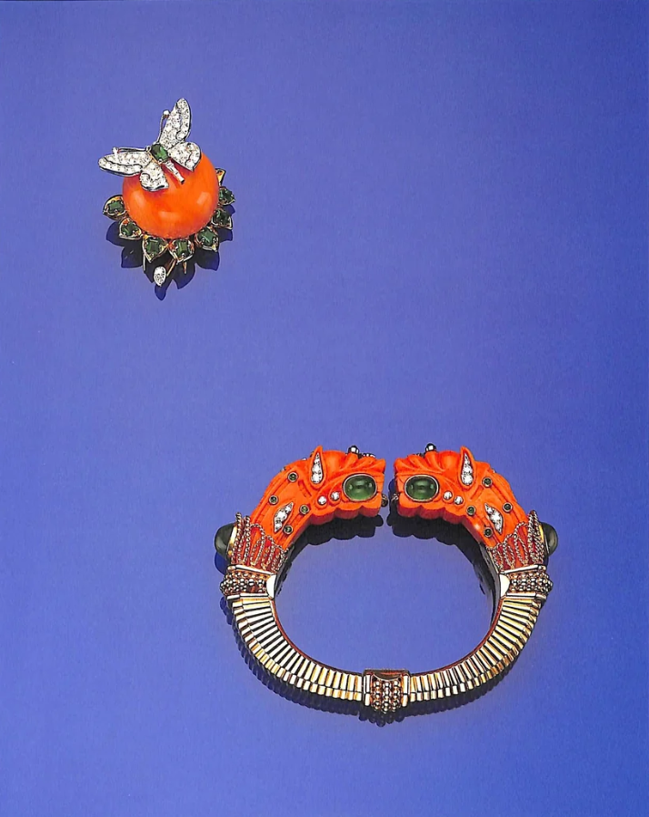 A coral and diamond dragonfly brooch and a coral, diamond, and cabochon cuff bracelet with stylised carved heads, from the 1987 Sotheby's sale catalogue.