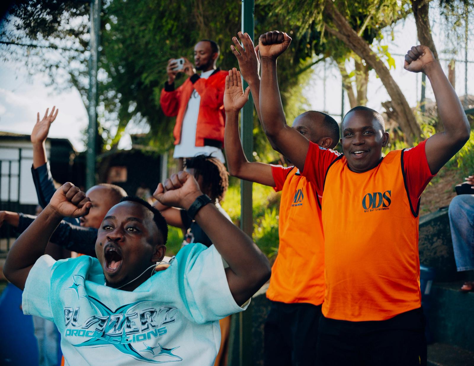 The terrace erupts with arms in the air