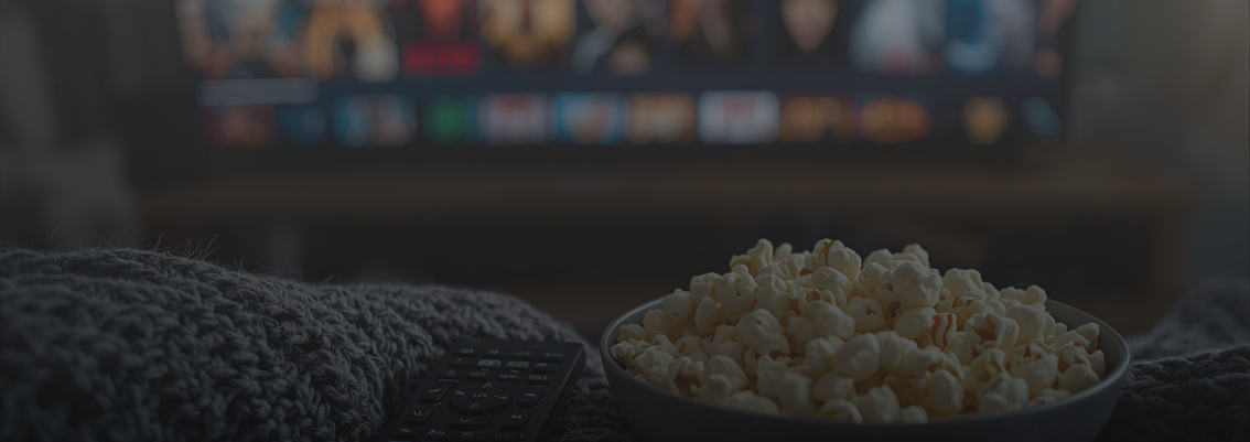 The November 2025 streaming watchlist for horor movie, featuring popcorn and a remote on a cozy blanket.