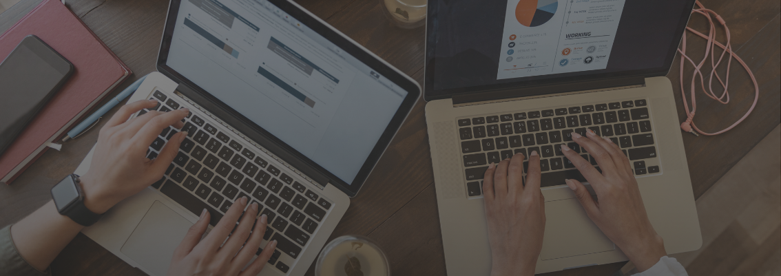 Two people working on laptops, displaying charts and digital documents to support productivity.